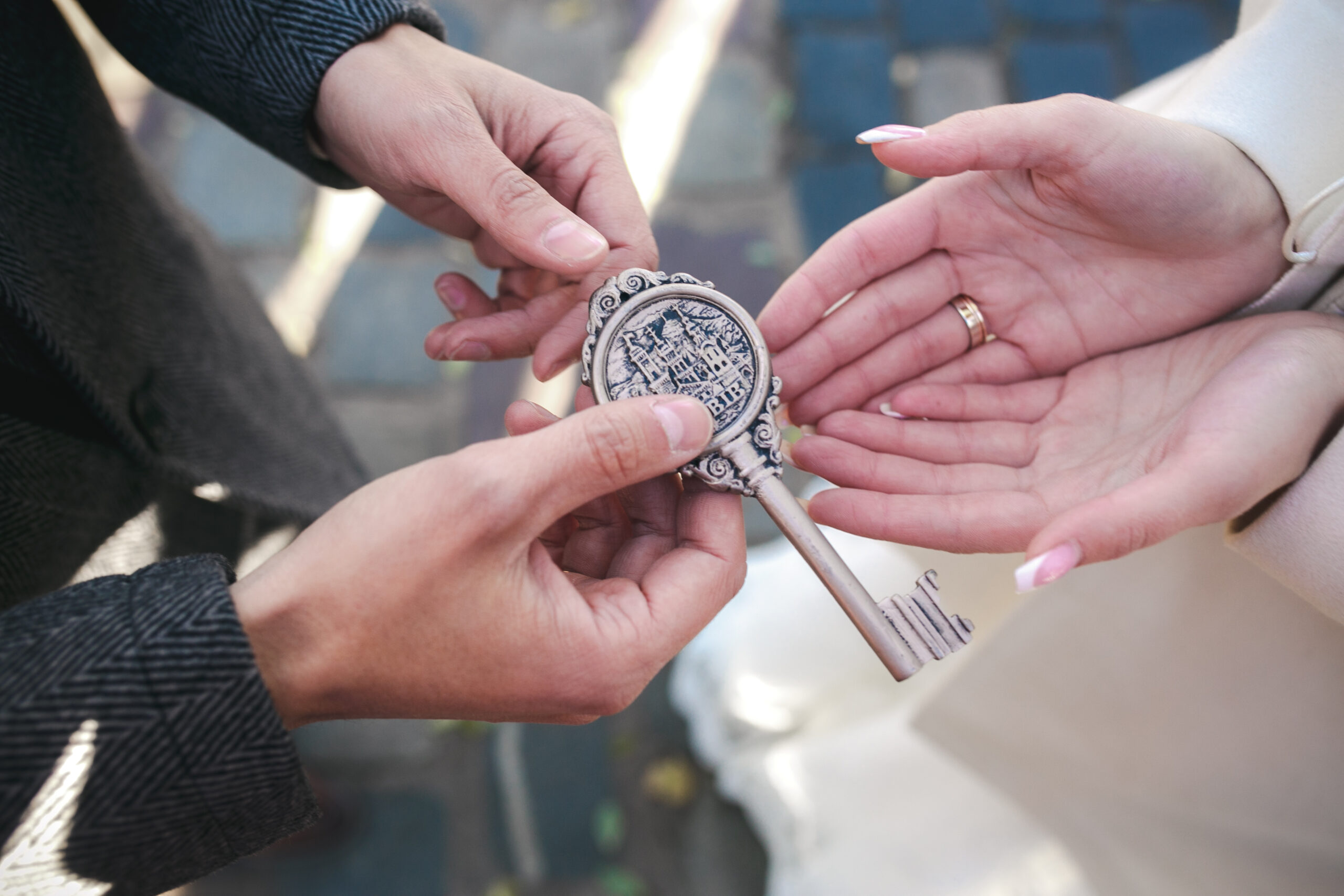 The lock with keys in hands of the groom and the bride